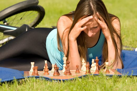 fitness woman playing chess outdoor