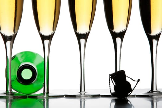 Two champagne glasses and a bottle in silhouette