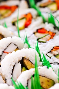 Close up on tray of assorted sushi appetizers