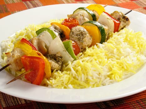 Seasoned chicken kebabs with bell peppers, onions, zucchini, and cherry tomatoes. Accompanied by a bed of saffron flavored basmati rice.