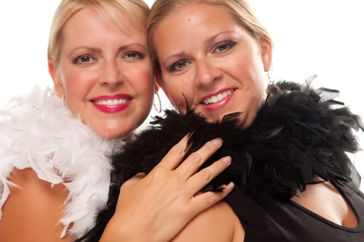 Portrait of Two Blonde Haired Smiling Girls with Feather Boas Isolated on a White Background.