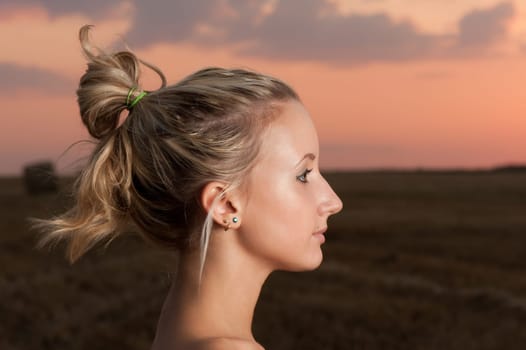 beautiful blond girl outdoor portrait at sunset