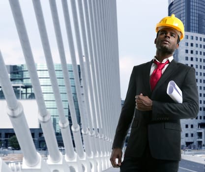 African american architect engineer with yellow hardhat and plans