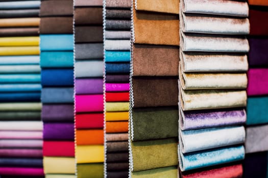 Many different colorful and bright fabric samples for upholstered furniture. Interior design concept. Close-up of a palette of textile abstract diagonal stripes of different colors. High quality photo