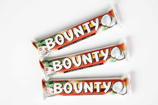 WETZLAR, GERMANY - 2022-10-03 - TChocolate bars with coconut of BOUNTY over bright background.