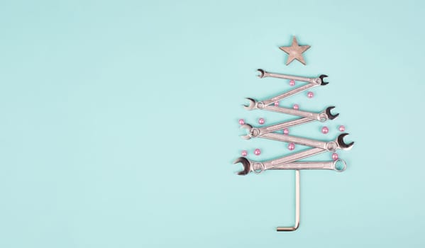 Christmas tree made with wrenches, baubels and a star, new year greeting card with repair tools