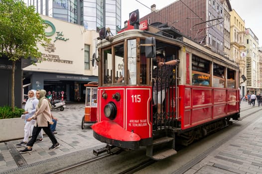 Istanbul, Turkey - August 25 2022: Nostalgic Taksim Tunel Red Tram, or tramvay, at Istiklal Street, Beyoglu district, central Istanbul, in a sunny summer day