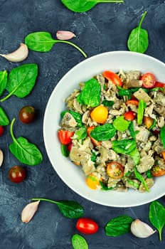 Tasty salad of baked eggplant, tomato and spinach.