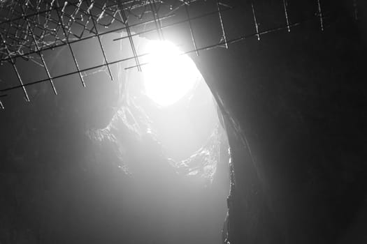 Rock cave with hole through which light shines. Underworlds in Sweden. Mystical atmosphere. Nature shot from Scandinavia