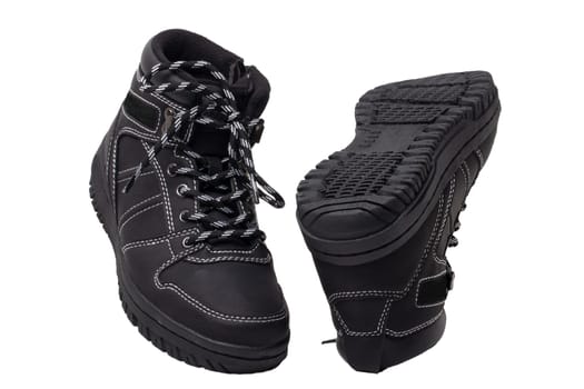 Winter boots. Close-up of a pair elegant black leather winter boots with laces and rivets isolated on white. Macro. Autumn shoe fashion for child boy.