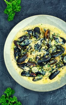 Cooked appetizing mussels in a creamy sauce