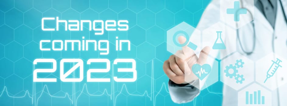 Doctor touching an icon on a futuristic interface - Changes coming in 2023