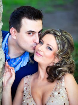 Newly wed couple kissing outdoor on a summer day.