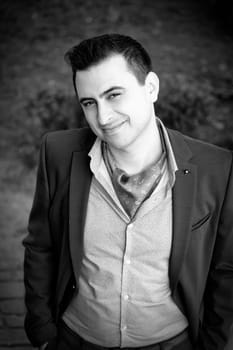 Portrait of groom on his wedding day outdoor.