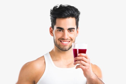 Handsome young man eating a healthy salad, isolated over a gray background