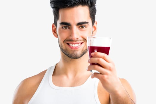 Handsome young man eating a healthy salad, isolated over a gray background