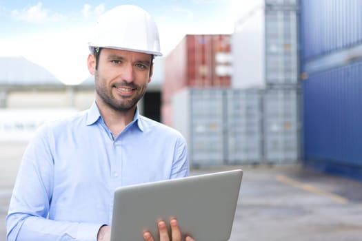 View of a Young Attractive engineer using laptop on the dock
