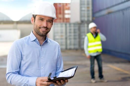 View of aYoung Attractive engineer consulting agenda on the dock