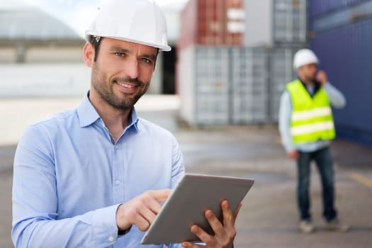 View of a Young Attractive engineer using tablet on the dock
