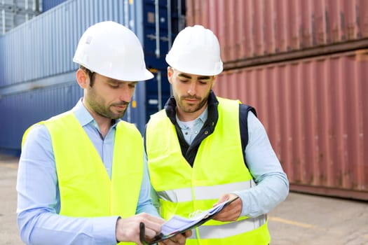 View of a Dock worker and supervisor checking containers data on tablet