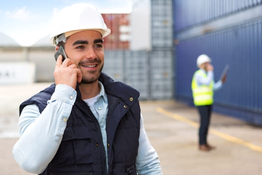 View of a Young Attractive docker using mobile phone at work