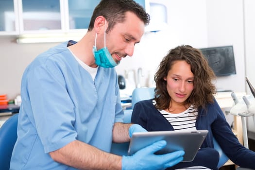 View of a Young attractive woman scared to being cured by a dentist