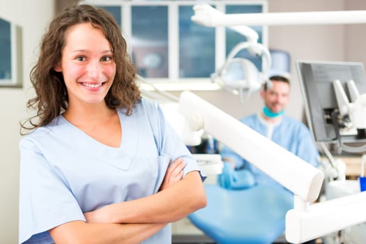 View of a young attractive dentist in his office