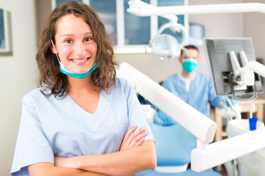 View of a young attractive dentist in his office