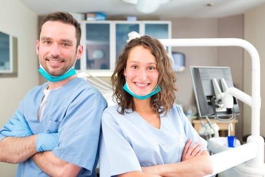 View of a Portrait of a young attractive dentist and his assistant in his office