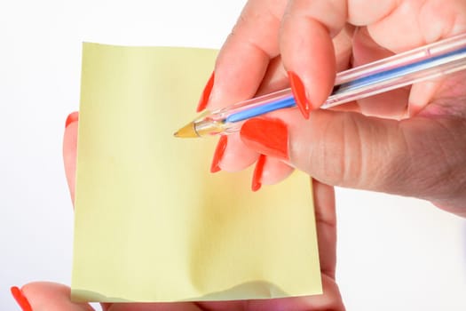 Woman's hand with painted nails holding blank letter paper on pure white background.