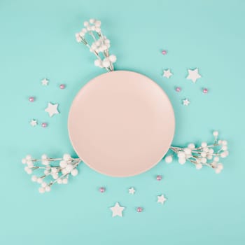 Empty plate, snow covered berries, rose colored baubles, christmas holiday and new year, festive dinner