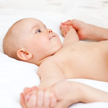Masseuse massaging little baby girl, shallow focus