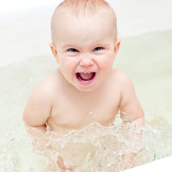 Cute little baby girl enjoying bathing