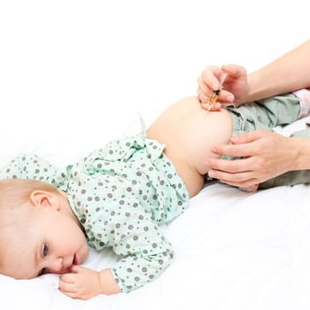 Doctor giving a child an intramuscular injection, shallow DOF