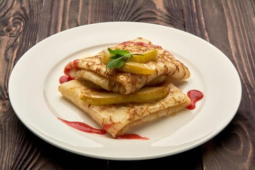 delicious juicy pancakes drizzled with sauce are served on a white plate. High quality photo