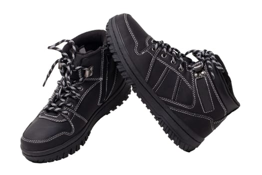 Winter boots. Close-up of a pair elegant black leather winter boots with laces and rivets isolated on white. Clipping path. Macro. Autumn shoe fashion for child boy.
