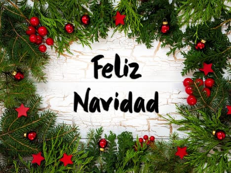 Christmas Card With Fir Branches And Spanish Text Feliz Navidad Means Merry Christmas. White Wooden Background With Vintage Design And Christmas Decoration Like Red Ornament Balls.
