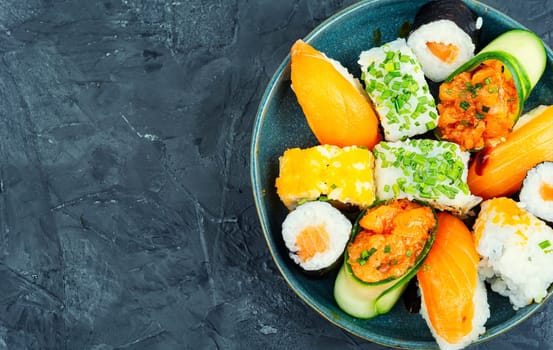 Appetizing colorful sushi rolls on the plate. Sushi menu. Japanese food. Space for text