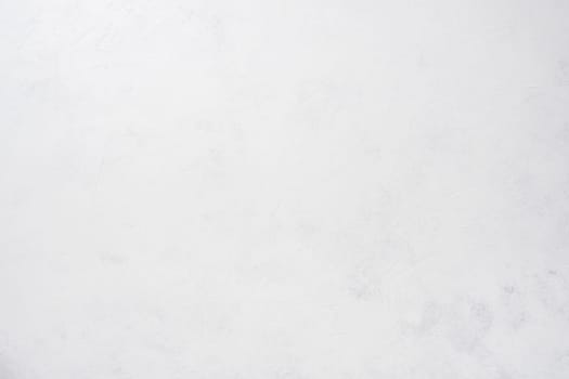 Background image of white uneven concrete surface. Top view. Copy space