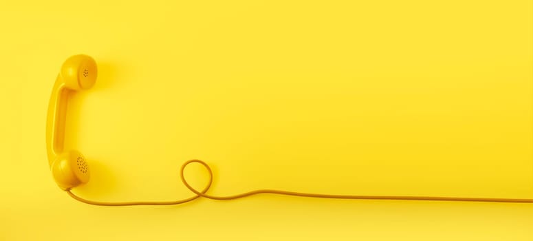 A yellow vintage dial telephone handset with yellow background.