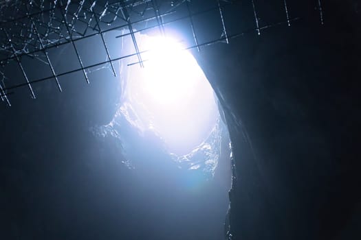 Rock cave with hole through which light shines. Underworlds in Sweden. Mystical atmosphere. Nature shot from Scandinavia