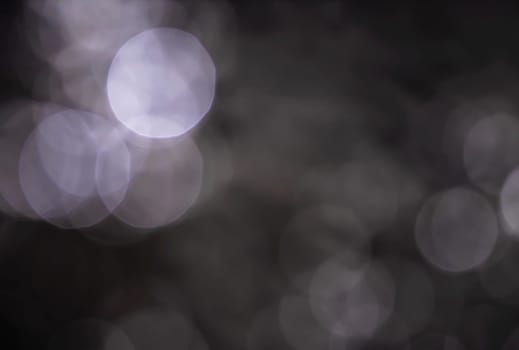 Light abstract dark bokeh christmas circle color glitter blurred black background