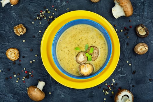 Tasty autumn soup on table. Autumn cream soup from champignon mushrooms.