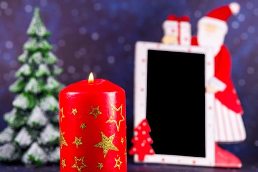 empty board with Santa Claus and burning candle