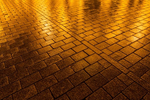 A wet cobblestone pavement in Berlin, Germany.