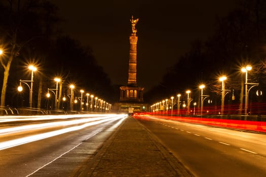 Traffic at night with the Berlin Victory Column at the background.
