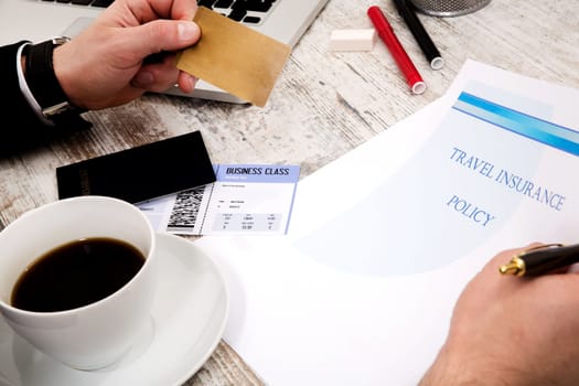 Travel insurance policy booklet with a boarding pass and a passport.