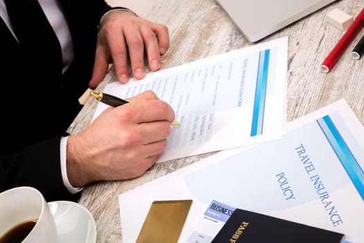 Travel insurance application form with a boarding pass and a passport.