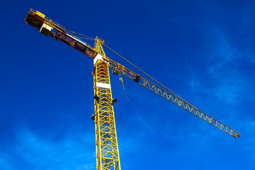 Construction crane against a blue sky.