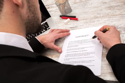 A businessman reading a Contract before signing.